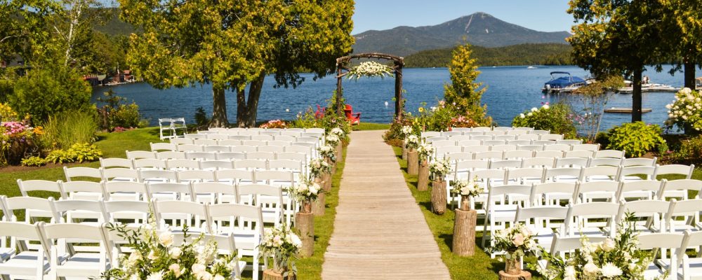 white folding chair in front of body of water