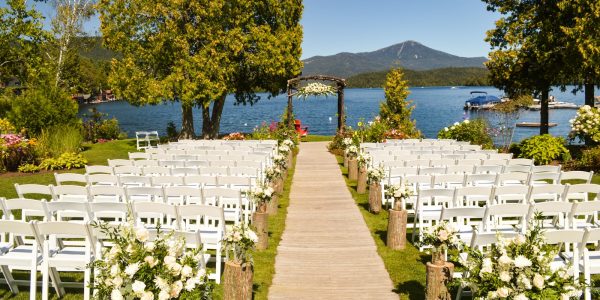 white folding chair in front of body of water