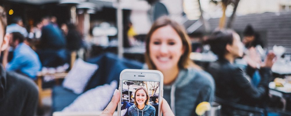 person taking photo of woman